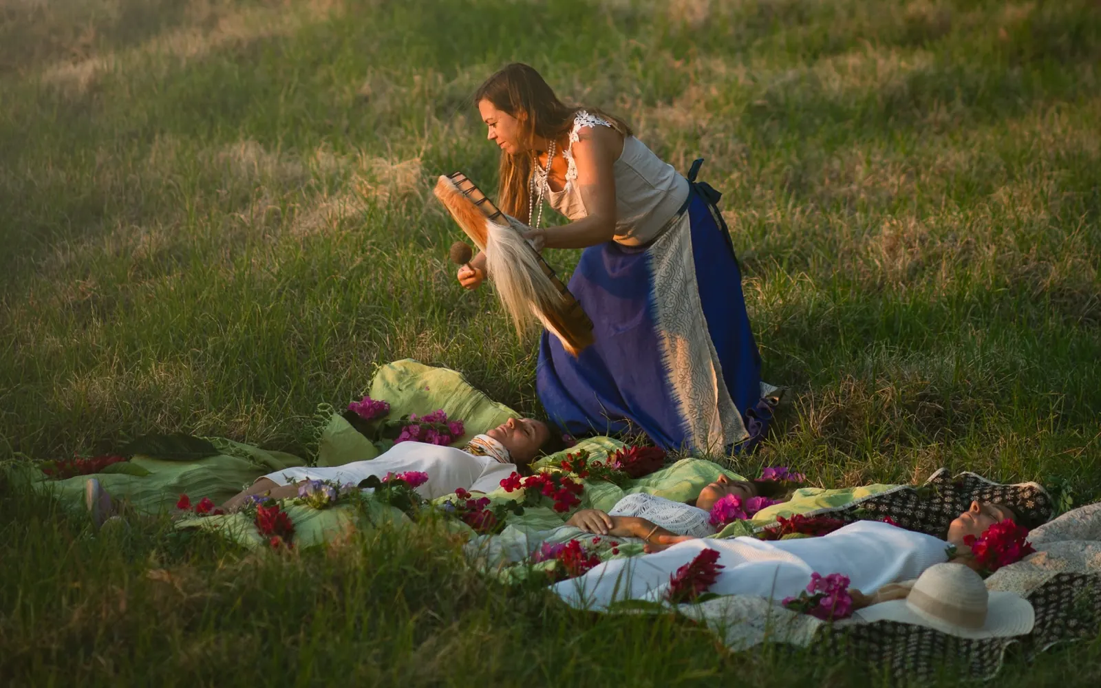 Body work on retreat: participants lying on cloths on a meadow on Madeira