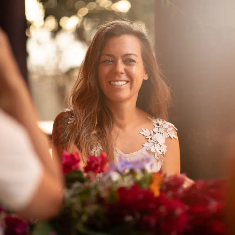 Sifu Tanja Fenz, martial arts teacher on Madeira, laughing at a table with flowers